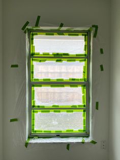 a window with green tape on it in a room