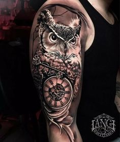 an owl with a clock on its arm is shown in black and grey tattoo style