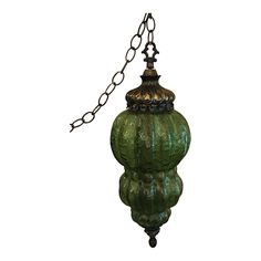 a green glass lamp hanging from a chain