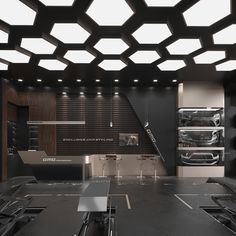 an empty kitchen with black counter tops and stainless steel appliances on the wall behind it