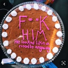 a cake with writing on it that says f k him he looked like a noodlee anyway