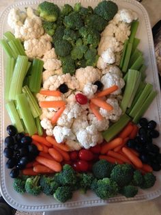 a platter with cauliflower, carrots, celery and cauliflower in the shape of a rabbit