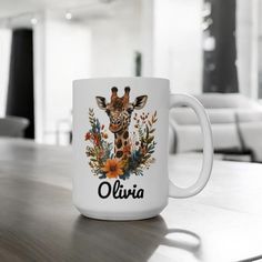 a white coffee mug with an image of a giraffe and flowers on it