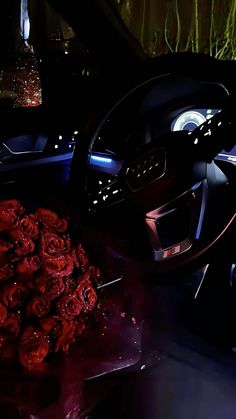 the interior of a car with roses on the floor and in front of the steering wheel