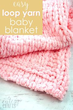 the easy loop yarn baby blanket with text overlay that says easy loop yarn baby blanket