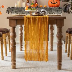 a dining room table decorated with halloween decorations