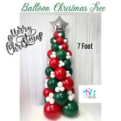 the balloon christmas tree has red, green and white balloons on it's base