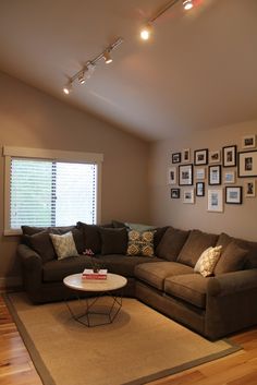 a living room filled with furniture and pictures on the wall