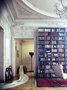 a living room filled with lots of furniture and bookshelves next to a doorway