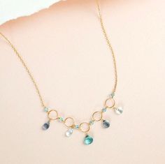 "Free Shipping on one of our best selling delicate blue gemstone necklaces! This modern classic necklace is tarnish resistant so it's made-to-last and a perfect gift. Necklace is handmade with individually selected gemstones. Extremely light and easy to wear everyday. It'll be your 'go to' necklace. Made with aquamarine, iolite and aqua aura quartz gemstones on a 14k gold plated chain. Our unique plating technique is tarnish resistant and plated over fine Italian sterling silver. Necklace is 16\ Light Blue Necklace, Blue Gemstone Necklace, March Birthstone Necklace, Aqua Aura Quartz, Making Necklaces, Metal Smithing, Beautiful Fairy, Quartz Gemstones, Aqua Aura