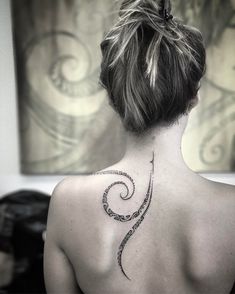 a woman with a tattoo on her back