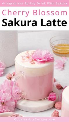 a cake with pink flowers on it and the words cherry blossom sakeura latte