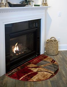 a fireplace with a fire in it and a basket on the floor next to it