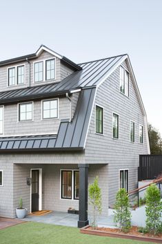 a house with a metal roof and white walls