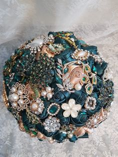 a close up of a brooch bouquet on a table