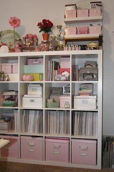 a book shelf filled with lots of crafting supplies on top of a hard wood floor