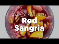 a blender filled with sliced up fruit and the words easy traditional red sangria