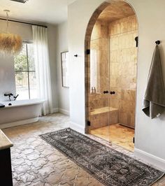 a bath room with a shower and a rug