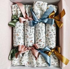 a box filled with lots of different colored wrapping paper wrapped in ribbon and bowknots