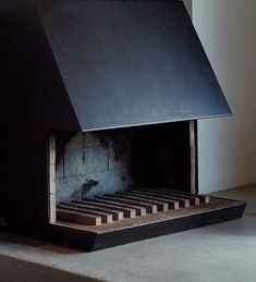 a fireplace with a black cover on the top and bottom part in front of it