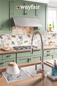 a kitchen with green cabinets and an advertisement for faucets from $ 50 on the wall