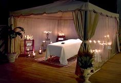 a room with candles and a bed in it