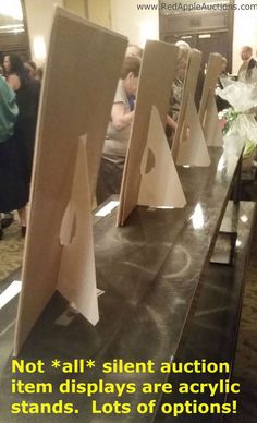 there are several pieces of cardboard on the counter in front of people sitting at tables