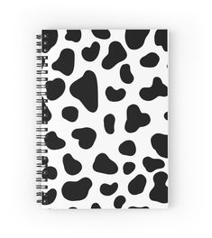 a black and white cow print spiral notebook