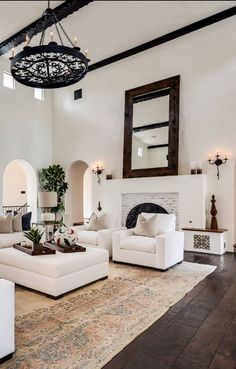 a living room filled with furniture and a fire place in the middle of an open floor plan