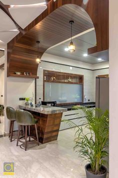 an open concept kitchen and dining area with wood accents, white tile flooring and ceiling lighting