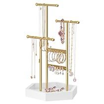 a gold jewelry rack with earrings and necklaces