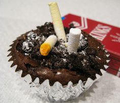 Brownie Ashtray.............. Brownies were baked in aluminum bake cups, then allowed to cool. The tops were smudged a little then sprinkled with crushed oreo cookies to resemble ashes. Finally candy cigarettes were placed as though they had been snuffed out in the brownie. Placing the cigarette box nearby adds to the illusion. This was a Freaky Food winner at our annual Halloween party. A whole tray of these looks pretty disgusting sitting on the food table. Gross Halloween Foods, Hillbilly Party, Food Pranks, White Trash Bash, Trash Bash, White Trash Party, Crushed Oreo, Trash Party, Crazy Party