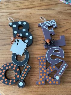 two wooden letters are decorated with polka dots and pumpkins, one is for the letter k