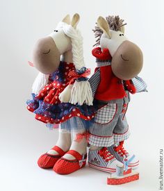 two stuffed donkeys dressed in red, white and blue clothing with shoes on their feet