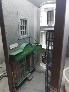 the inside of a doll house with furniture and accessories in it's display case