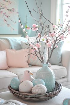 a white couch sitting next to a table filled with eggs and flowers in a vase