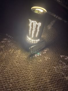 a radio sitting on top of a table next to a light fixture with the word monster written on it