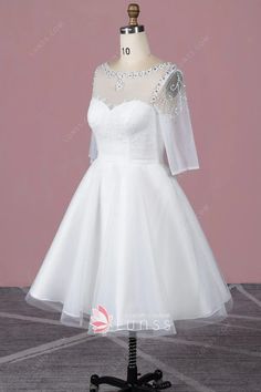 a short white wedding dress on a mannequin