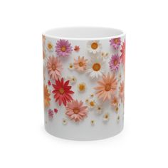 a white mug with pink and orange flowers on it