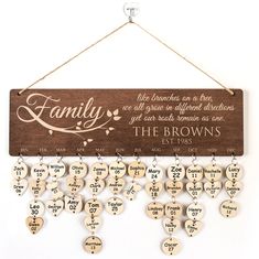 a wooden sign that says family with hearts hanging from it