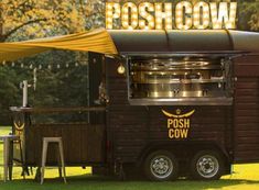 a food truck parked in the grass with a sign above it that says poshow