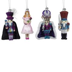 three ornaments in the shape of nutcrackers are hanging from strings on a white background