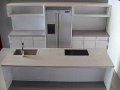 a modern kitchen with white cabinets and stainless steel appliances