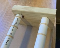 two white pipes sitting on top of a wooden table