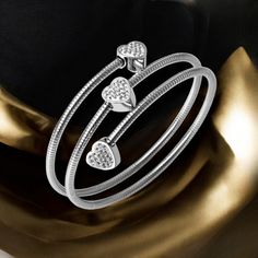 Elevate Your Wrist Game With This Stunning 18k White Gold Plated Stainless Steel Layered Rope Bangle Wrap Bracelet, Featuring Three Sparkling Heart-Shaped Zircon Inlaid Charms. Perfect For Stacking Or Wearing Solo, This Versatile Piece Adds A Touch Of Elegance To Any Outfit. Whether You're Dressing Up For A Special Occasion Or Adding A Bit Of Sparkle To Your Everyday Look, This Bracelet Is A Must-Have Accessory. -Can Fit Any Wrist Size -Heart Charms With Zircon Inlays Measure 0.30"W Fast Shippin Silver Wrap Bracelet, Wrist Accessories, Triple Heart, Wrap Bangles, Modern Gold Jewelry, Gold Wrap, Wrist Game, Versatile Jewelry, Wrist Wrap