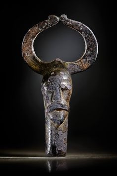 an ancient statue with horns on it's head is shown against a black background