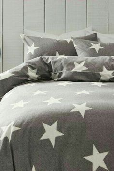 a bed with grey and white stars on it