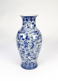 a blue and white vase sitting on top of a table