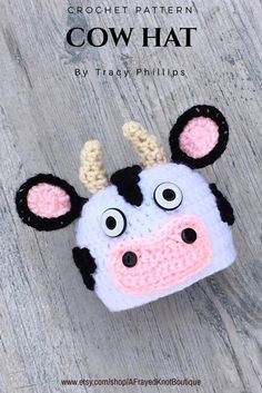 a crocheted cow head on top of a wooden table with the words, cow hat