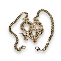 Add an edge of sophistication to your look with the Python Bracelet. This bold snake bracelet features a coiled serpent centerpiece, meticulously crafted with intricate detailing that symbolizes power and transformation. Made with a sleek shiny finish, this bracelet is designed to make a statement. The unique double-clasp design ensures a secure and comfortable fit while adding versatility to the piece. Perfect for both day and night, the serpent bracelet brings an element of fierce elegance to any outfit. Its timeless design and attention to detail make it an essential addition to any jewelry collection. Exposure to the salt from sweat can cause your pieces to become dull. Be mindful that perfume, hairspray and hand lotions may tarnish your gold filled jewelry due to the harsh chemicals t Metal Snake-shaped Jewelry With Adjustable Chain, Snake Shaped Metal Jewelry With Adjustable Chain, Snake-shaped Metal Jewelry With Adjustable Chain, Adjustable Snake Shape Chain Jewelry, Snake Chain Jewelry As Gift, Adjustable Snake-shaped Metal Jewelry, Adjustable Snake Shaped Metal Jewelry, Adjustable Tarnish-resistant Snake-shaped Jewelry, Serpent Bracelet